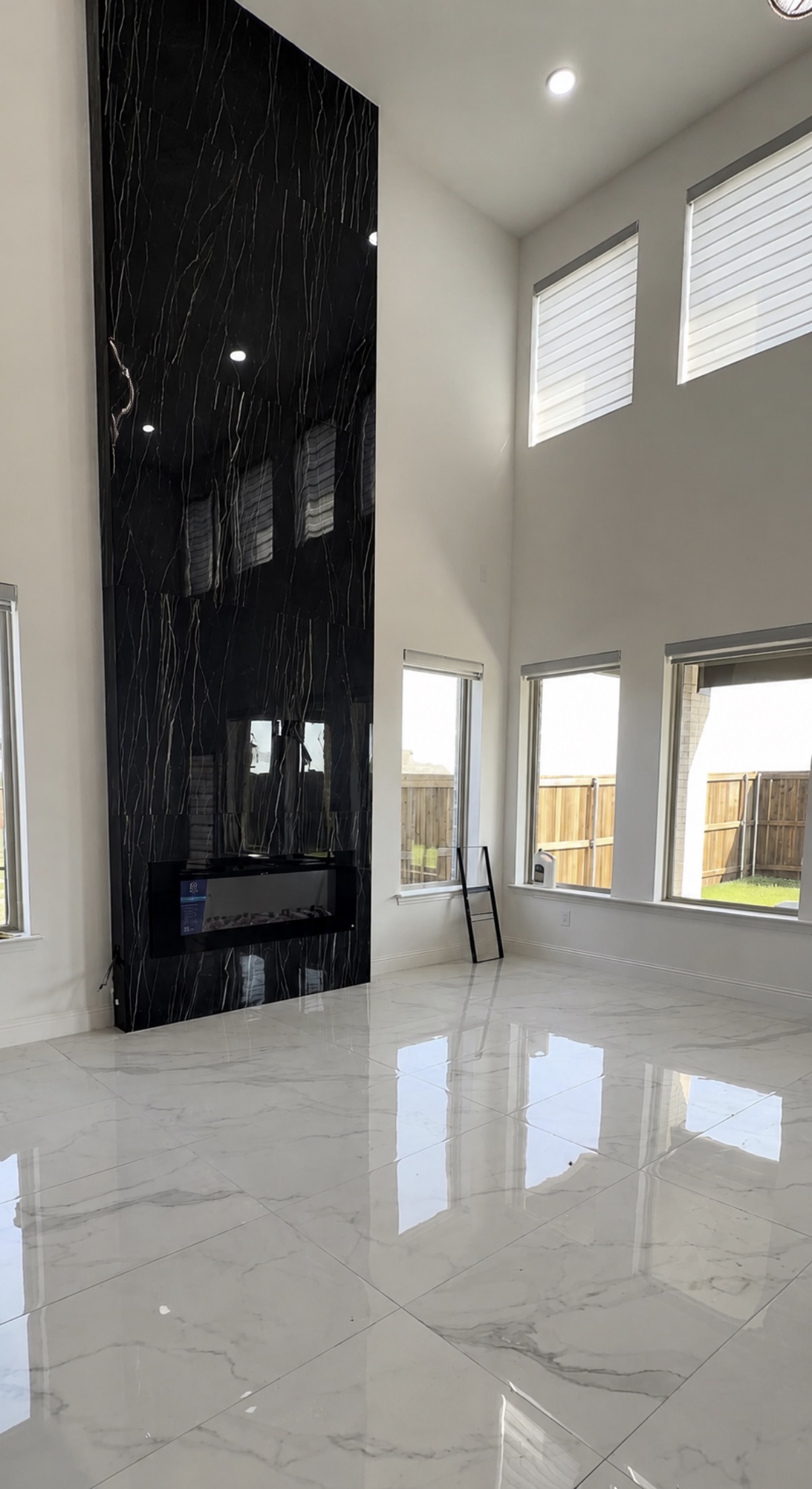 Midnight Onyx high-gloss black porcelain slab fireplace feature wall by Obsidian Walls